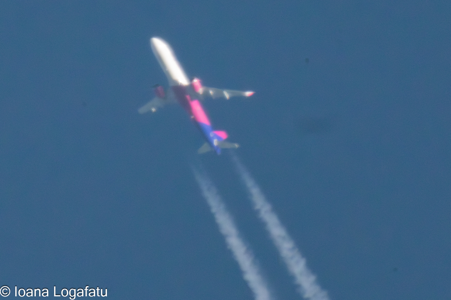 Plane high above clouds with vapor trails